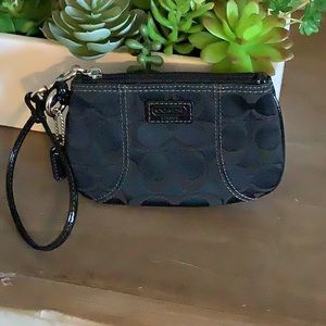 Coach wristlet. Black material with patent trim. Never used.
